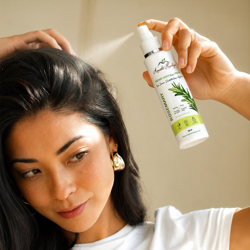 Rosemary Water 100 ml spray bottle being used on the scalp